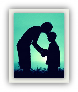 Silhouette of mother kissing child on head